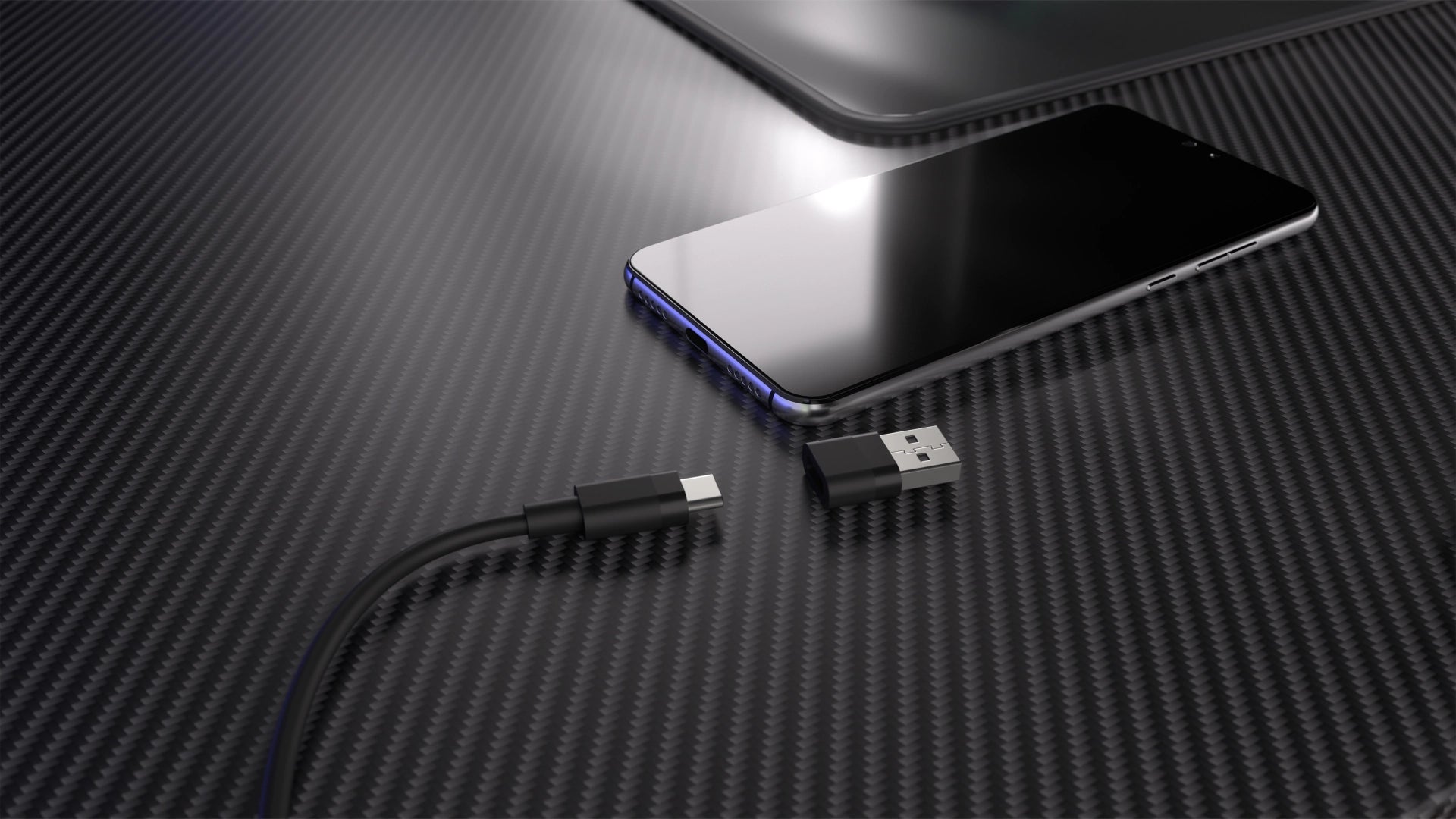 Zbliżenie na przewód USB-C z adapterem USB-A oraz spoczywający obok smartfon 