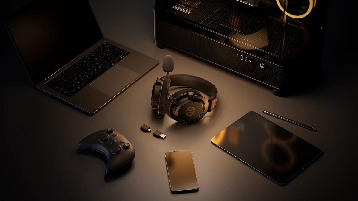 ENDORFY Viro Infra Wireless headphones placed on a desk alongside a laptop, gamepad, smartphone, tablet, and desktop computer, highlighting their multi-device compatibility