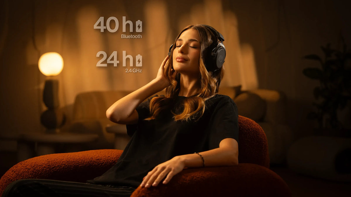 Woman sitting in a chair wearing the ENDORFY Viro Infra Wireless headphones