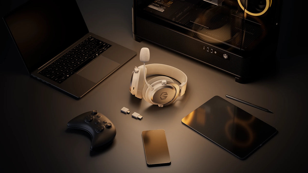 ENDORFY Viro Infra Wireless Onyx White headphones placed on a desk alongside a laptop, gamepad, smartphone, tablet, and desktop computer, highlighting their multi-device compatibility
