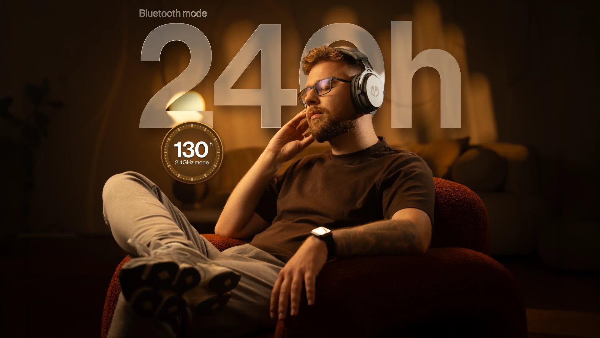 A model sitting in an armchair wearing ENDORFY Viro Wireless Alt Gray headphones