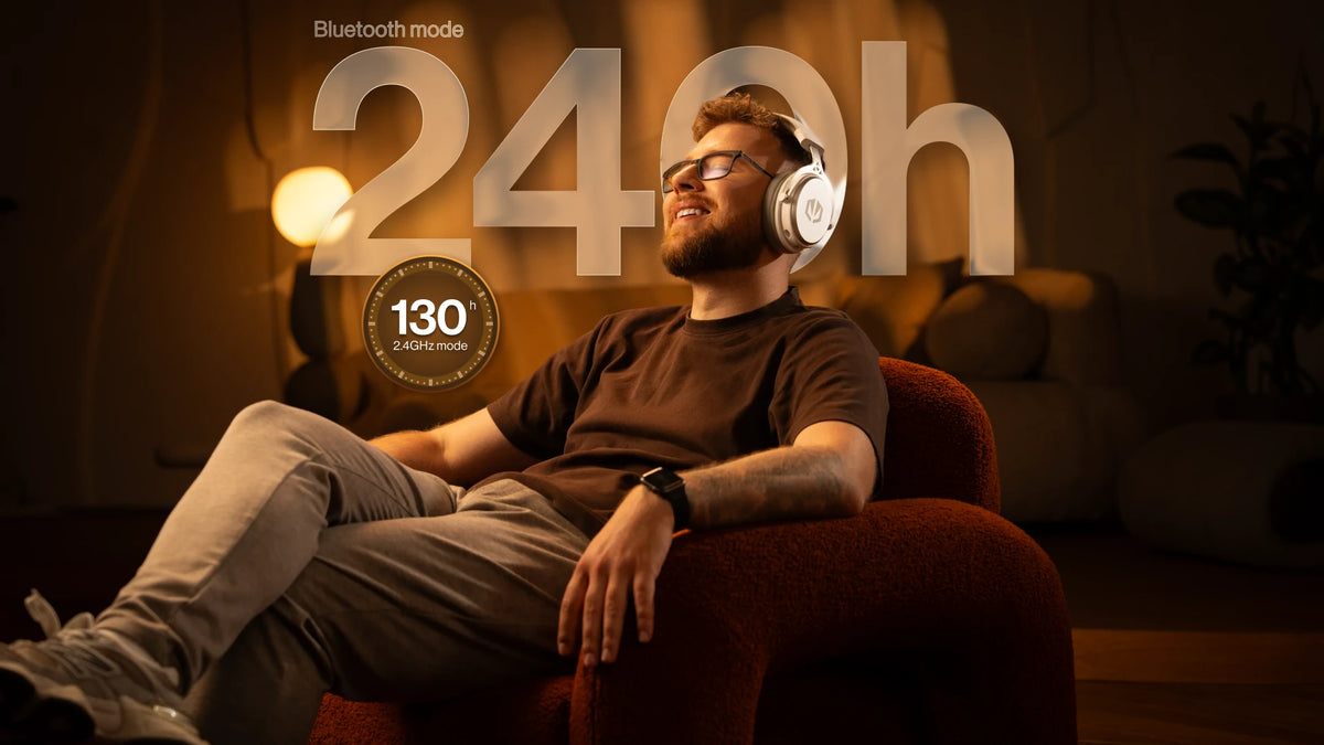 A model sitting in an armchair wearing ENDORFY Viro Wireless Onyx White headphones