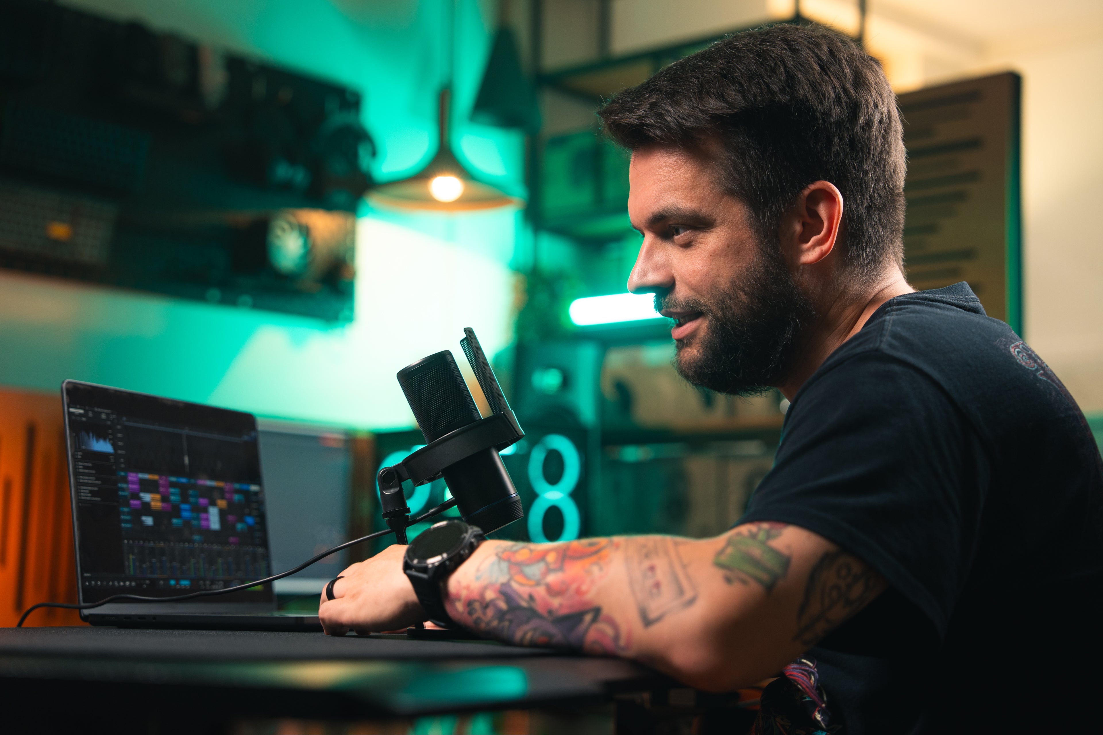 Model speaking into the Solum 2 microphone set up on a desk